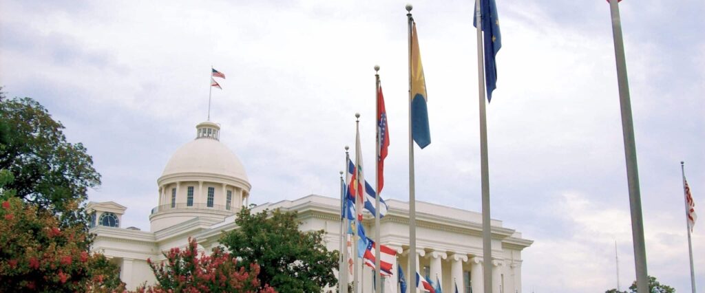 The Alabama State Capitol in Montgomery AL & man walking on premises while traveling USA’s 50 States