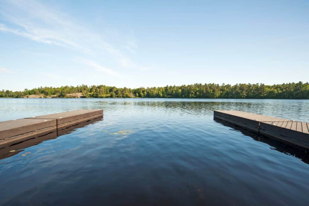 55084,Wooden docks over still river in rural landscape